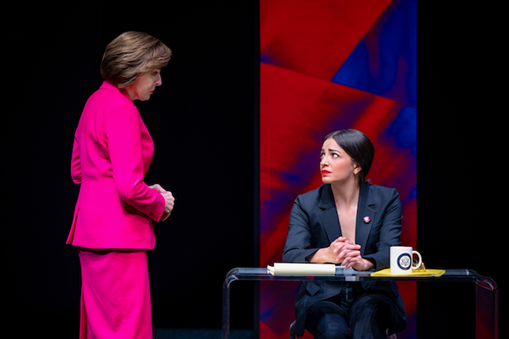 A person in a pink suit looking at another person in a suit