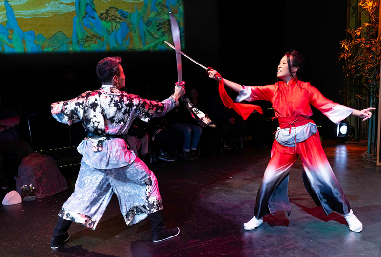 A person and person in traditional clothing holding swords