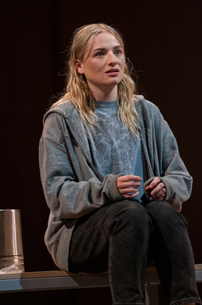 A person sitting on a stage