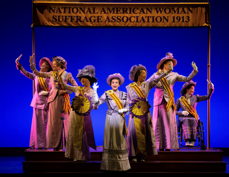 A group of women in clothing on a stage