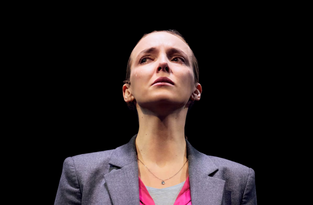 A picture containing person, suit, person, wearing