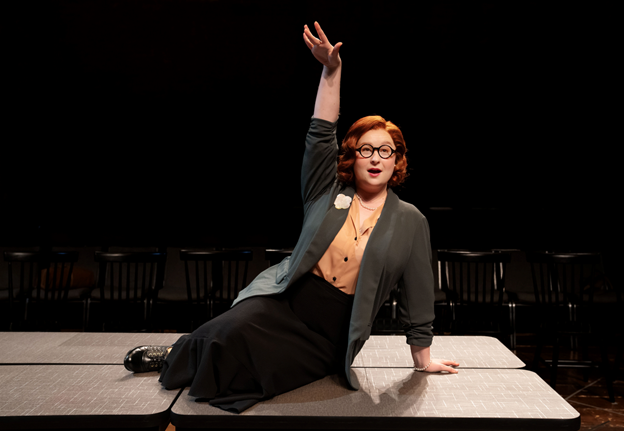 A person sitting on a table with her hand up