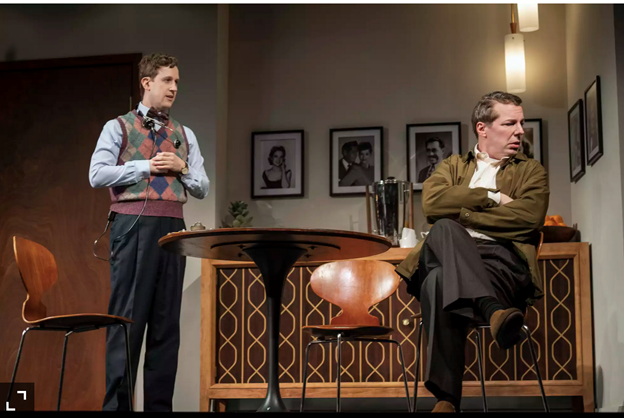 A person sitting in a chair next to a person standing next to him with low confidence