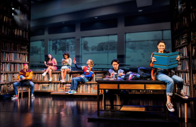 A group of people sitting on a bench in a library with low confidence