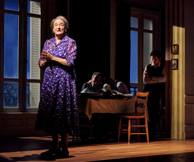 A person in a dress standing on a stage